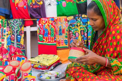 Women making tribal art of india